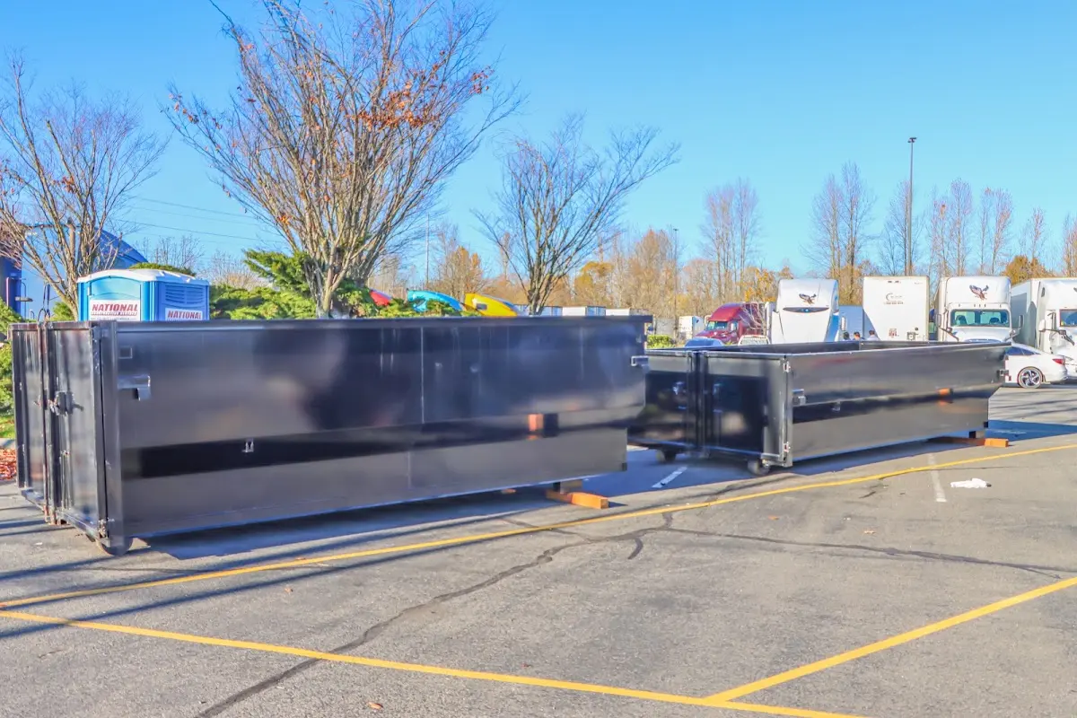 Professional dumpster rental service with roll-off container on residential driveway in Twin Lakes